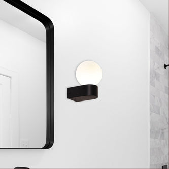 Oriel bathroom light beside a framed mirror